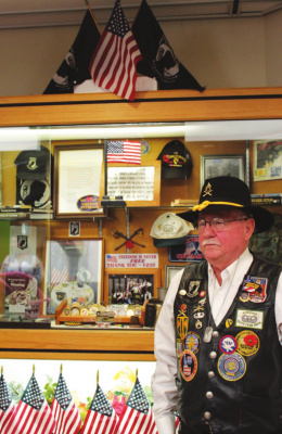 Billie Hair, an Army Airborne Vietnam War veteran, filled a display case at the Hulsey Public Library with memorabilia emblematic of the sacrifices made by American military personnel over the years. Hair is especially focused on MIA/POWs. The display will be at the library through November. HANK MURPHY PHOTO